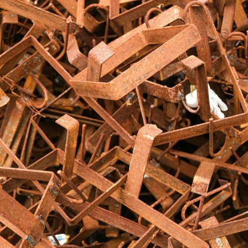 Detailed close-up of rusty metal scrap with selective focus, ideal for industrial themes.